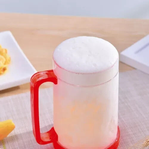 Clear mug with red handle on a table with food in the background